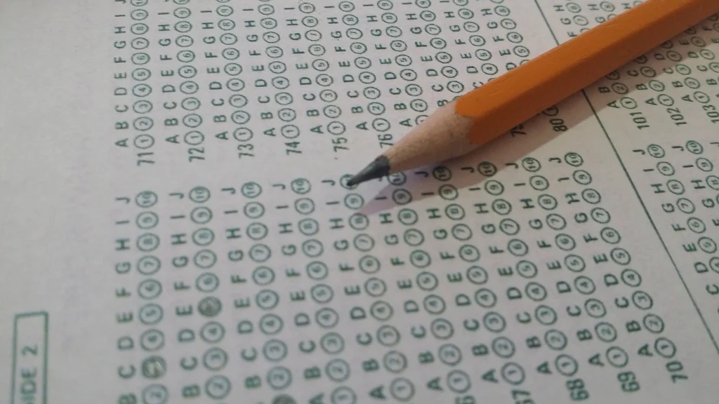 A pencil resting on a multiple-choice answer sheet